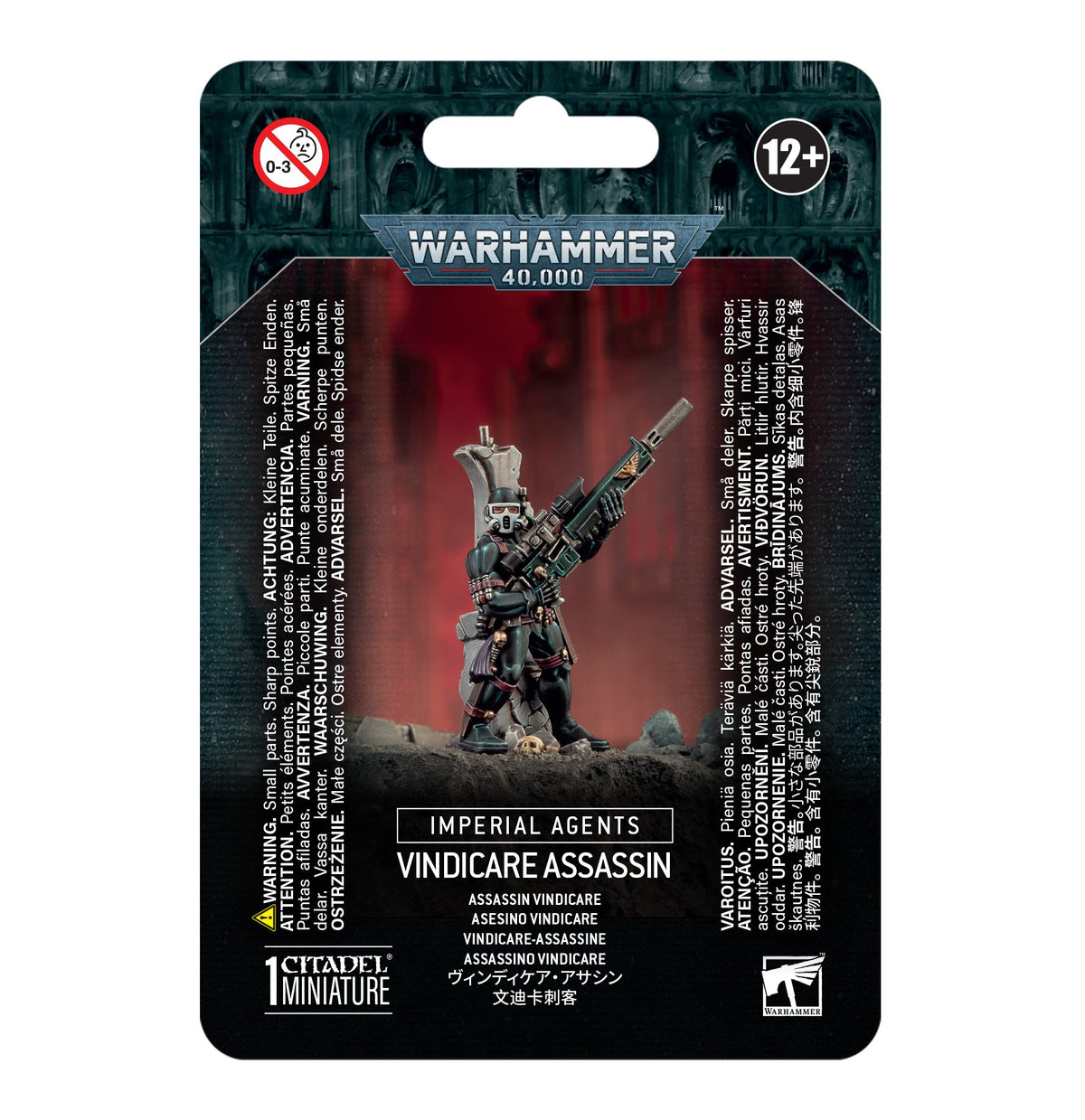 Front of a dark teal and black Warhammer 40,000 package, with a masked miniature in dark armor holding a long rifle against a red backdrop. The card reads “IMPERIAL AGENTS” and “VINDICARE ASSASSIN,” with “12+” at the top.