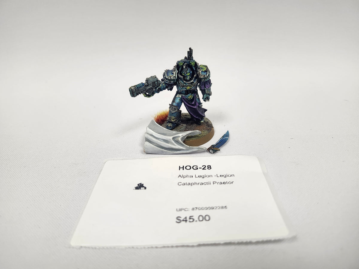 Painted miniature of an Alpha Legion Cataphractii Praetor, a heavily armored warrior in teal and blue-green power armor with a purple cloak, holding a large gun, on a round base with a sculpted white banner and a small blue blade. A white label card in front reads "HOG-28", "Alpha Legion -Legion" and "Cataphractii Praetor".