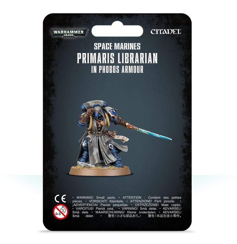 Front of black packaging showing a blue-armored Space Marine miniature in a gray robe, holding a glowing blue sword on a round base. The card reads “SPACE MARINES PRIMARIS LIBRARIAN IN PHOBOS ARMOUR,” with Warhammer 40,000 and Citadel logos.