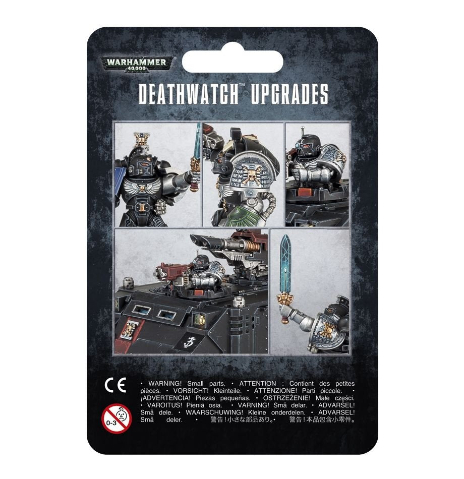 Front of a black, mottled backing card for a Deathwatch upgrade frame, with a collage of black-armored Space Marines, shoulder details, a vehicle and a raised blue sword. The card reads “WARHAMMER 40,000” and “DEATHWATCH UPGRADES.”