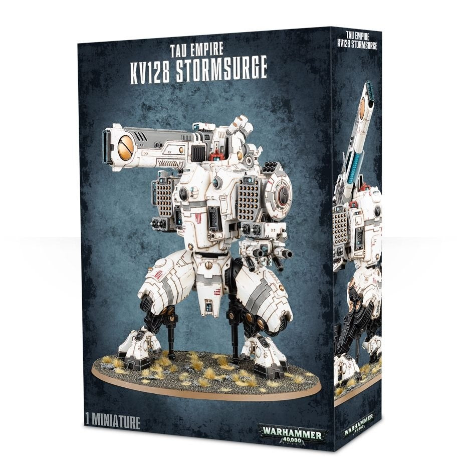 Box for a Tau Empire KV128 Stormsurge miniature, showing a white armored mech with dark joints, teal and orange accents, and heavy weapons standing on an oval base. The side panel shows a second view with a raised weapon; the box reads “TAU EMPIRE,” “KV128 STORMSURGE,” and “1 MINIATURE.”