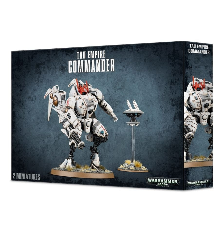 Box front and right side for a Tau Empire Commander miniature set, showing a white armored battlesuit with red accents beside a small hovering drone on a stand. The box reads “TAU EMPIRE COMMANDER” and “2 MINIATURES.”
