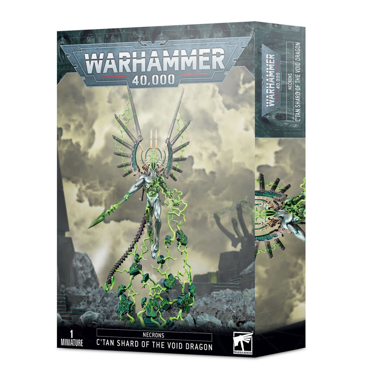 Warhammer 40,000 miniature box showing the silver C’Tan Shard of the Void Dragon floating above a rocky base, surrounded by bright green energy and a spiked halo. The narrow side panel shows a partial close-up; front text reads “WARHAMMER 40,000” and “C’TAN SHARD OF THE VOID DRAGON.”