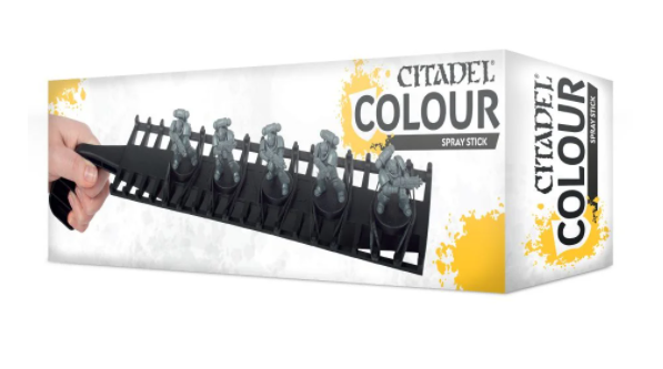 White box packaging for a Citadel Colour Spray Stick, with yellow paint-splash graphics and a side panel. The front shows a hand holding a black pegged rack carrying several gray miniatures, beneath the text “CITADEL COLOUR” and “SPRAY STICK”.