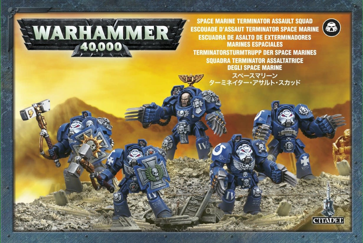 Front of a Warhammer 40,000 box showing five blue-armored Terminator miniatures with varied weapons on rocky rubble against a yellow background. The logo reads “WARHAMMER 40,000,” with “SPACE MARINE TERMINATOR ASSAULT SQUAD” above the figures.