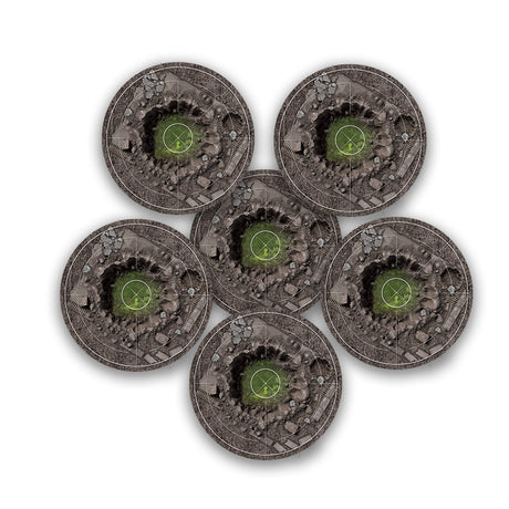 Six round FLG objective markers arranged in a cluster, each printed with a gray-brown rubble field, a dark crater-like center, and a small green target circle with white tactical markings.