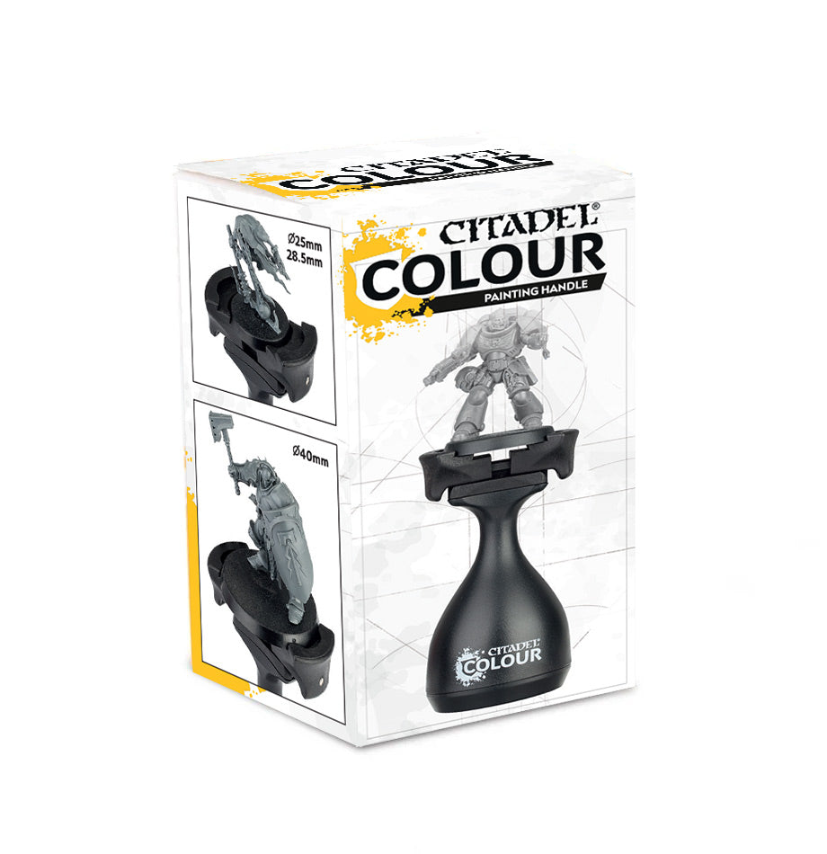 White box with yellow accents for a black Citadel painting handle; the front shows the handle holding a gray miniature, while two side-panel diagrams show it holding miniatures on different bases. The box reads “CITADEL COLOUR” and “PAINTING HANDLE.”