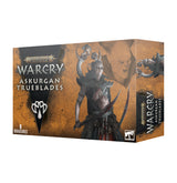 Warcry: Askurgan Trueblades miniature box shown from the front and right side, with ochre and black artwork of an armored fantasy warrior and another figure on the side. The front reads “WARCRY,” “ASKURGAN TRUEBLADES,” and “8 MINIATURES.”