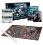 Warhammer 40,000 Ultimate Starter Set displayed with a box, rulebooks and reference sheets above blue armored Space Marine and pink-purple Tyranid miniatures arranged around gray terrain on a brown play mat, with dice and measuring rulers. The box reads “ULTIMATE STARTER SET.”