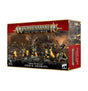 A red-and-black Warhammer box shown from the front and right side, with artwork of armored green orruks in yellow and dark armor wielding weapons on a rocky battlefield. The front reads “WARHAMMER AGE OF SIGMAR” and “ORRUK ARDBOYZ.”