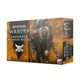 Angled view of an orange-brown miniature game box, with fantasy artwork of green-faced creatures, one framed by shaggy fur. The front reads “WARCRY” and “KRULEBOYZ MONSTA-KILLAZ”; the narrow side repeats the title.
