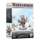 Warhammer miniature box shown from the front and left side, with a colorful red-and-blue Gloomspite Gitz figure in a tan hood against a snowy scene. The packaging reads “WARHAMMER COMMEMORATIVE SERIES” and “GROTMAS GITZ.”