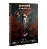 Book shown at an angle with its front cover and spine visible. The cover depicts a white-haired figure with enormous dark blue-gray wings holding a staff against a red background; text reads “WARHAMMER AGE OF SIGMAR,” “DAWNBRINGERS,” and “BOOK V SHADOW OF THE CRONE.”