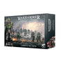 Boxed Warhammer: The Horus Heresy Solar Auxilia Lasrifle Section, shown from the front and right side. The artwork depicts green-armored soldiers with rifles on a smoky battlefield; the box reads “SOLAR AUXILIA LASRIFLE SECTION” and “20 CITADEL MINIATURES.”