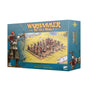 Blue-green box for Bretonnia Peasant Bowmen, with a large archer illustration at left and a regiment of miniature bowmen behind defensive stakes across the front. The front reads “WARHAMMER THE OLD WORLD” and “KINGDOM OF BRETONNIA PEASANT BOWMEN”; an archer is pictured on the right side panel.