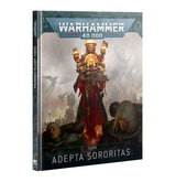 Angled view of the Codex: Adepta Sororitas book cover, featuring a red-and-gold armored woman holding a weapon, with two figures in the foreground and flames behind her. The cover reads “WARHAMMER 40,000” and “CODEX ADEPTA SORORITAS.”