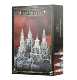 Box for Civitas Imperialis Spires, with artwork of four ornate pale gray gothic towers rising above city buildings against a red-brown sky; the side panel shows tower details. The front reads “LEGIONS IMPERIALIS” and “CIVITAS IMPERIALIS SPIRES.”