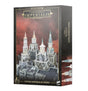 Box for Civitas Imperialis Spires, with artwork of four ornate pale gray gothic towers rising above city buildings against a red-brown sky; the side panel shows tower details. The front reads “LEGIONS IMPERIALIS” and “CIVITAS IMPERIALIS SPIRES.”