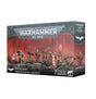Box for Inquisitorial Agents miniatures, shown from the front and right side. The front depicts a group of seven armed figures on rocky ground against a red, ruined-city backdrop, with “WARHAMMER 40,000” and “INQUISITORIAL AGENTS” lettering.
