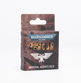 A maroon and brown, weathered-print Warhammer 40,000 Imperial Agents dice box stands upright, with tan dice bearing black markings visible through a front window. The package displays the text “WARHAMMER 40,000” and “IMPERIAL AGENTS DICE.”