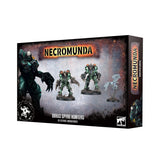 Necromunda miniature box shown at an angle on a white background, with a dark rust-and-gray front featuring a large armored figure and images of two green-and-black hunters and a pale winged figure. The front reads “NECROMUNDA” and “ORRUS SPYRE HUNTERS”; the narrow side repeats the Necromunda title.