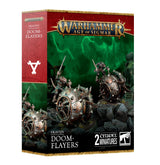 Front of a red, green and black Games Workshop box showing two spiked, weathered metal Doom-Flayer wheel machines with rat-like pilots on rocky ground. The box reads “WARHAMMER AGE OF SIGMAR,” “SKAVEN DOOM-FLAYERS” and “2 CITADEL MINIATURES.”