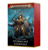 Box of Stormcast Eternals Warscroll Cards shown upright, with a gold-armored warrior holding an axe and shield against a blue battlefield scene; the box has red side panels and gold trim. The front reads “WARHAMMER AGE OF SIGMAR,” “WARS CROLL CARDS,” and “STORMCAST ETERNALS.”