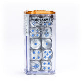 A clear plastic case with an orange lid holds silver, pearlescent dice with bright blue pips and sunburst emblems. The label reads “WARHAMMER THE OLD WORLD” and “HIGH ELF REALMS DICE SET.”