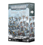 Product box for "WARHAMMER 40,000" "COMBAT PATROL" "SPACE WOLVES", shown at an angle with front and side panels visible. The cover art depicts painted miniatures in blue-grey armor with yellow shoulder pads and fur-clad warriors on snowy rocky terrain, labeled "21 CITADEL MINIATURES" with a white wolf-head logo.