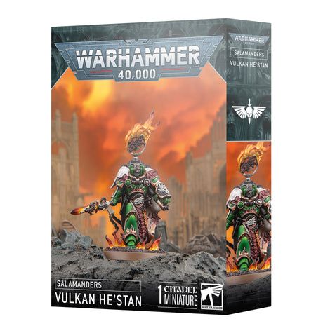 Retail box for the Warhammer 40,000 miniature "SALAMANDERS VULKAN HE'STAN", showing front and side panels. The box art depicts a painted green-armored warrior holding a flaming weapon with fire at his feet and a burning halo behind his head, against an orange sky and ruins, with text "WARHAMMER 40,000" and "1 CITADEL MINIATURE".