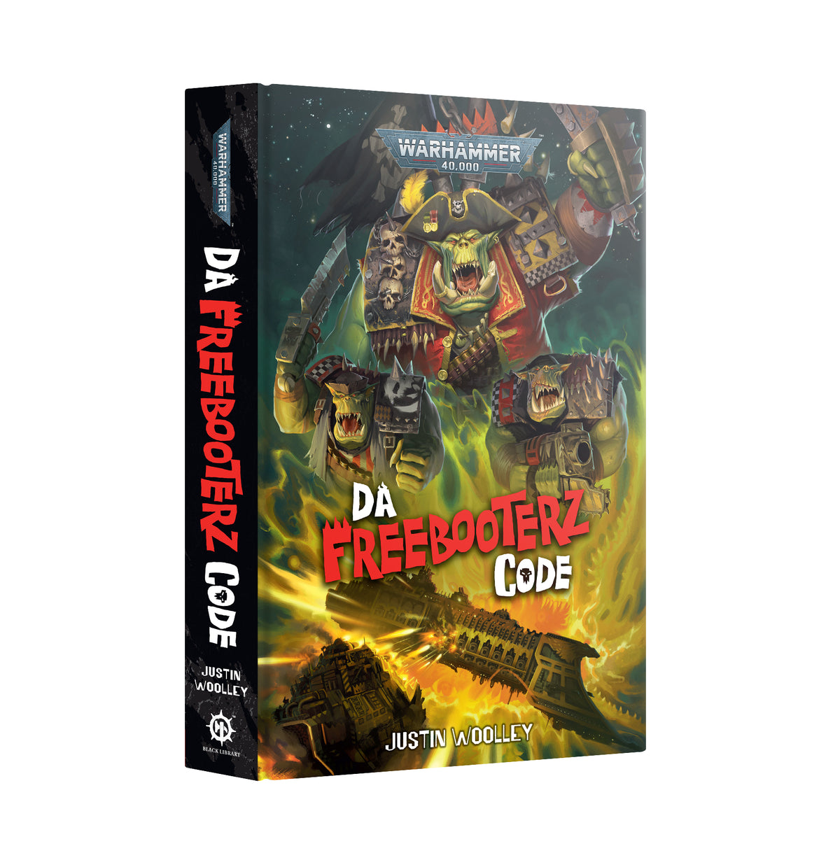 Hardback book shown at a three-quarter angle revealing the front cover and spine. The cover depicts a green ork pirate captain in a tricorn hat and red coat brandishing a blade, with two smaller orks and a spaceship amid green and yellow flames. Text reads "WARHAMMER 40,000", "DA FREEBOOTERZ CODE" and "JUSTIN WOOLLEY"; the spine repeats the title vertically.