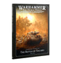 Softcover book shown at an angle revealing the spine and front cover. The cover reads "WARHAMMER THE HORUS HERESY" at the top and "JOURNAL TACTICA THE BATTLE OF TALLARN PART ONE" at the bottom, with artwork of a tank and towering war machines in a dusty orange battlefield.