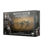 Product box for the Warhammer: The Horus Heresy kit, shown at an angle revealing the front and side panels. The dark gray box features artwork of armored ogryn warriors in a dusty battlefield, with a close-up of a figure wearing a clawed gauntlet, and white text reading "WARHAMMER THE HORUS HERESY", "SOLAR AUXILIA" and "CHARONITE OGRYN SECTION".