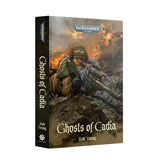 Hardcover book 'Ghosts of Cadia' by Rob Young shown at an angle revealing the spine and front cover. The cover art depicts a helmeted soldier lying prone and aiming a long rifle amid rubble with fiery orange explosions behind, under a 'WARHAMMER 40,000' logo; the spine repeats the title and author with a 'BLACK LIBRARY' mark.
