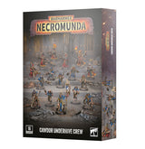 Box for the Necromunda: Cawdor Underhive Crew miniature set, showing painted figures in red and blue robes wielding guns, torches and banners on a rubble-strewn floor. The top reads "WARHAMMER NECROMUNDA" and the bottom "CAWDOR UNDERHIVE CREW" beside a "16 CITADEL MINIATURES" badge and Warhammer logo.
