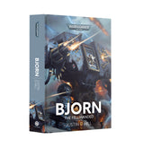 Hardback book shown at an angle revealing the front cover and spine. The cover bears the "WARHAMMER 40,000" logo above an illustration of a blue-grey armored war machine with gold trim firing weapons amid lightning and flames, with the title "BJORN", subtitle "THE FELL-HANDED" and author "JUSTIN D HILL" in white. The grey-blue spine repeats the title, author and a Black Library logo.