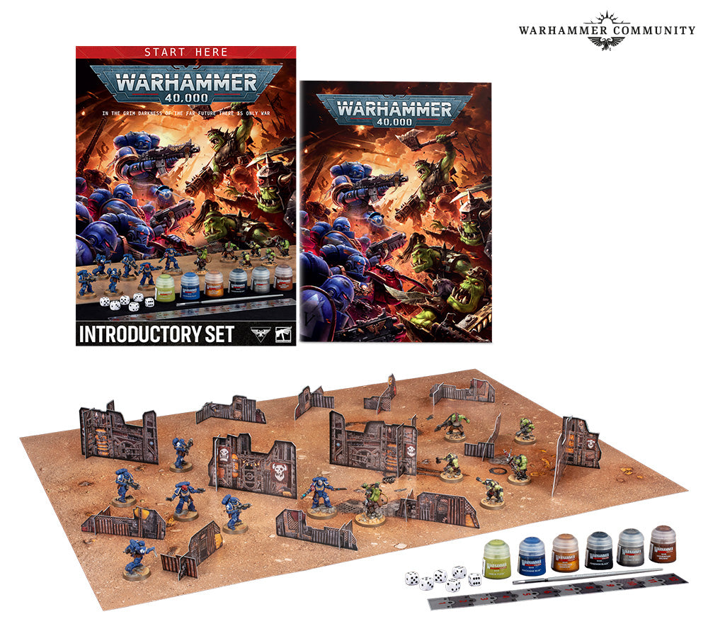 Warhammer 40,000 Introductory Set contents: a box cover reading "START HERE", "WARHAMMER 40,000" and "INTRODUCTORY SET", a matching handbook, and a laid-out battle scene with blue Space Marine and green Ork miniatures among cardboard ruin terrain on a sandy mat, plus paint pots, dice and a ruler. "WARHAMMER COMMUNITY" logo appears top right.