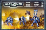 Front of a Space Marines: Terminator Squad box, showing blue, heavily armored warriors with weapons amid a yellow-orange battlefield scene. The top banner reads “WARHAMMER 40,000”; smaller lettering is too small to read clearly.