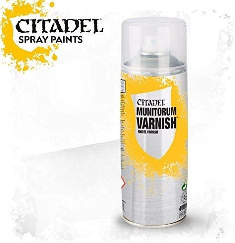 A front-facing spray can of varnish with a clear cap and a yellow, white and gray splatter design. Its label reads “CITADEL MUNITORUM VARNISH,” and the upper-left graphic reads “CITADEL SPRAY PAINTS.”