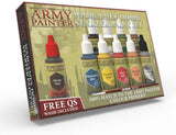 Angled view of The Army Painter hobby paint set box, with several dropper bottles in assorted colors and a larger wash bottle with a red cap displayed on the front. The package reads “THE ARMY PAINTER WARGAMES HOBBY STARTER PAINT SET” and “FREE QS WASH INCLUDED.”
