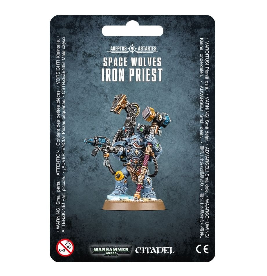 Front of a dark mottled package displaying a blue-gray armored Space Wolves miniature with gold and copper details, a raised hammer-like tool, a gun and a round tan base. The package reads “SPACE WOLVES IRON PRIEST” and “CITADEL.”