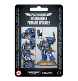 Front of a black Ultramarines upgrade package, labeled “SPACE MARINES” and “ULTRAMARINES PRIMARIS UPGRADES.” It shows a blue-armored Space Marine holding a sword and pistol, with smaller close-ups of the helmet, head, weapon and armor details.