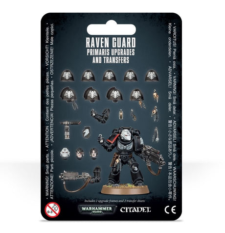 Black Raven Guard upgrade kit packaging displays a black-armored miniature with a red shoulder stripe, surrounded by shoulder pads, heads, weapons and small accessories. The card reads “RAVEN GUARD PRIMARIS UPGRADES AND TRANSFERS” and “CITADEL.”