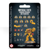 Front of a black hanging package showing a yellow Imperial Fists armored miniature with a raised fist, surrounded by yellow shoulder pads, weapons, heads and other upgrade parts. The title reads “IMPERIAL FISTS PRIMARIS UPGRADES AND TRANSFERS,” with Warhammer 40,000 and Citadel logos along the bottom.