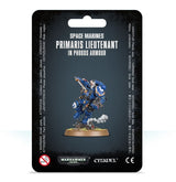 Front of a black blister card package featuring a blue-armored Space Marine miniature with gold trim, a white helmet, and a round scenic base. The card reads “SPACE MARINES” and “PRIMARIS LIEUTENANT IN PHOBOS ARMOUR,” with Warhammer 40,000 and Citadel logos along the bottom.