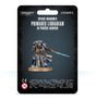 Front of black packaging showing a blue-armored Space Marine miniature in a gray robe, holding a glowing blue sword on a round base. The card reads “SPACE MARINES PRIMARIS LIBRARIAN IN PHOBOS ARMOUR,” with Warhammer 40,000 and Citadel logos.