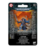Front of a Warhammer 40,000 Space Marines miniature package, showing a blue-armored Captain holding a large blade against an orange background. The black package reads “WARHAMMER 40,000,” “SPACE MARINES” and “CAPTAIN IN GRAVIS ARMOUR.”