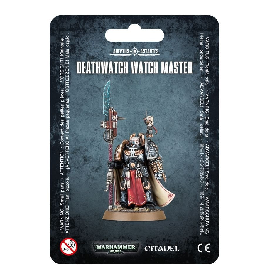 A Watch Master miniature in ornate black, silver and gold armor, with a red front cloth, cream cape and upright spear with a blue blade, is displayed on a dark textured package card. The card reads “DEATHWATCH WATCH MASTER” and shows “WARHAMMER 40,000” and “CITADEL” logos.