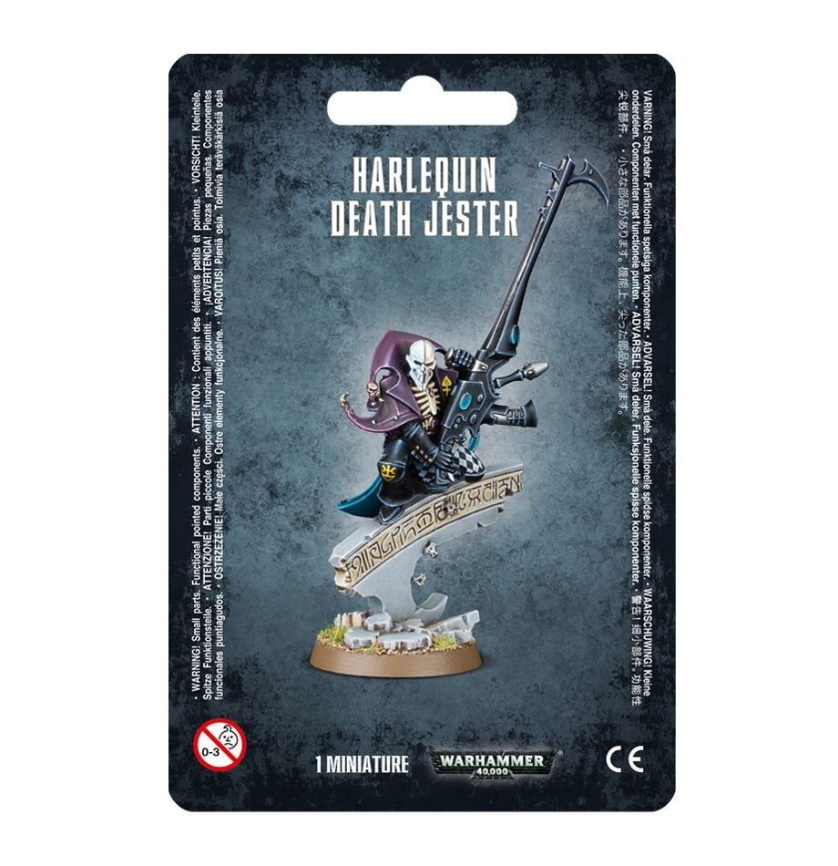 Front of a dark blue-gray Harlequin Death Jester miniature package, showing a masked figure in black, purple and teal clothing holding a long gun above a decorated base. The card reads “HARLEQUIN DEATH JESTER” and “1 MINIATURE.”
