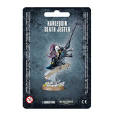 Front of a dark blue-gray Harlequin Death Jester miniature package, showing a masked figure in black, purple and teal clothing holding a long gun above a decorated base. The card reads “HARLEQUIN DEATH JESTER” and “1 MINIATURE.”